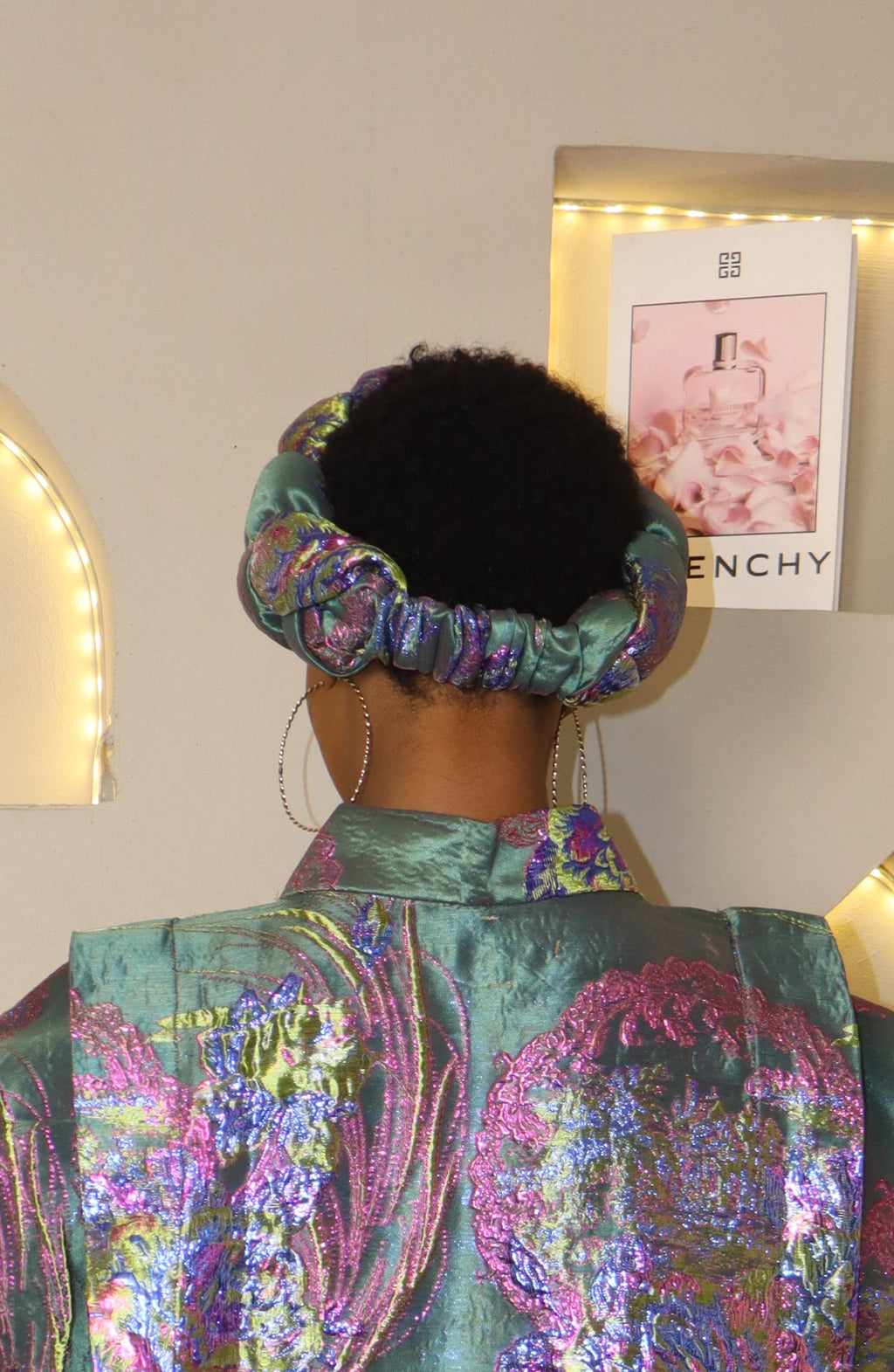 Woman wearing a teal headband with a blurred background