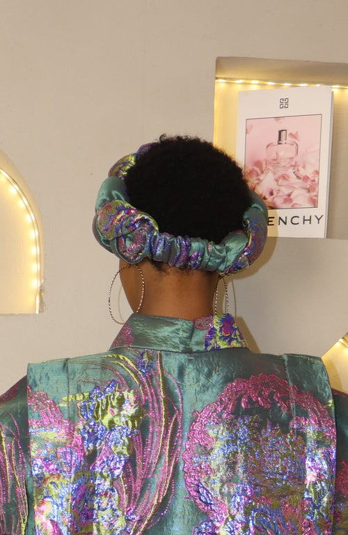 Woman wearing a teal headband with a blurred background